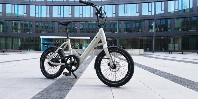 20 Zoll, aber fährt wie ein Großes: Tenways CGO Compact im Test Tenways CGO Compact in Sandstone Beige vor urbanem Hintergrund